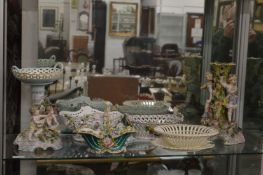 Two floral encrusted centre pieces, three floral encrusted baskets and a creamware basket and