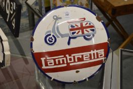 A circular enamel sign.
