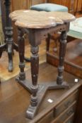 An Elizabethan style oak trefoil shaped occasional table.