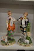 A pair of pottery figure groups.