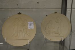 A pair of Parian ware circular plaques.
