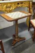 A 19th century rosewood pedestal table, the top inset with a chest board design each panel with