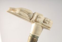 A WALKING STICK WITH CARVED BONE HANDLE as a nude.