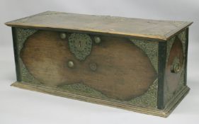 AN ISLAMIC BRASS MOUNTED HARDWOOD COFFER, 134cm wide, 55cm high, 56cm deep.