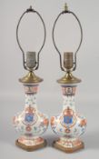 A PAIR OF CHINESE ARMORIAL STYLE PORCELAIN AND ORMOLU TABLE LAMPS. 19ins high including fitting