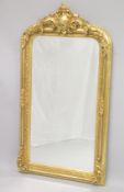 A DECORATIVE VICTORIAN STYLE GILT FRAMED OVER MANTLE MIRROR. 5ft 3ins high x 2 ft 9ins wide.