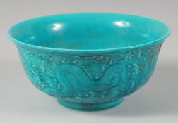 A CHINESE TURQUOISE GLAZED CIRCULAR BOWL with moulded decoration. 6ins diameter.