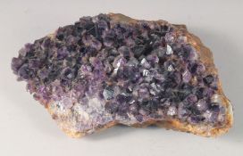 A LARGE AMETHYST CRYSTAL. 11ins long.