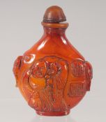 A CHINESE CARVED AMBER STYLE SNUFF BOTTLE. 7.5cm high.