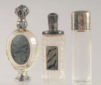 THREE SILVER MOUNTED CUT GLASS SCENT BOTTLES.