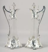 A PAIR OF ART NOUVEAU STYLE WMF GLASS CLARET JUGS WITH PLATED MOUNTS. 16.5
