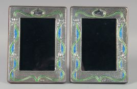 A PAIR OF SILVER AND ENAMEL PHOTOGRAPH FRAMES. 19.5cm high