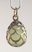 A SILVER AND JADE EGG SHAPED PENDANT, of cage design. 2cm high