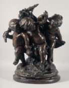 A LARGE AND IMPRESSIVE BRONZE GROUP OF THREE PLAYFUL CHERUBS. 22ins high.