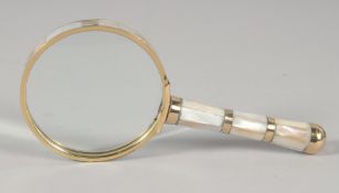 A SMALL MAGNIFYING GLASS with MOTHER OF PEARL handle.