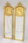 A PAIR OF DECORATIVE GILTWOOD NARROW MIRRORS, the upper sections with moulded female busts. 5ft
