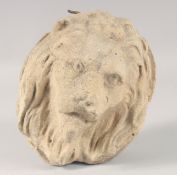 A 17TH CENTURY CARVED STONE LION BOSS.
