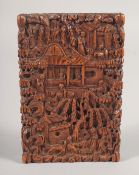 A CHINESE CANTON SANDALWOOD CARD CASE, carved with a busy village scene, 10.5cm x 7cm.