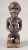AN ANTIQUITY, PRE-COLOMBIAN SOUTH AMERICAN POTTERY SEATED FIGURE. 6ins high.