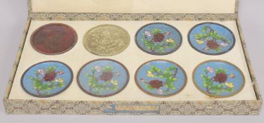 A BOXED SET OF EIGHT JAPANESE DISHES SHOWING THE STAGES OF CLOISONNE PRODUCTION.