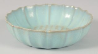 A CHINESE CELADON PETAL FORM BOWL, with carved characters, 22cm diameter.