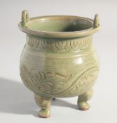 A CHINESE LONGQUAN CELADON TRIPOD CENSER, with carved foliate decoration, 15.5cm high.