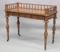 A 19TH CENTURY WALNUT WRITING TABLE with spindle back, sliding drawer with fall front, on turned