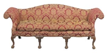 A GEORGE III STYLE MAHOGANY FRAMED THREE SEATER HUMP BACK SETTEE with scroll arms on carved cabriole
