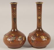 A PAIR OF JAPANESE MIXED METAL INLAID BRONZE VASES, each relief decorated with native flora and