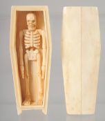 A BONE COFFIN CONTAINING A SKELETON. 11.5cm long