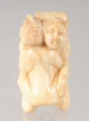 A CHINESE CARVED BONE EROTIC NETSUKE. 4.5cm