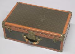 A LOUIS VUITTON SUITCASE. 2ft long x 1ft 3.5ins wide x 8.5ins high.