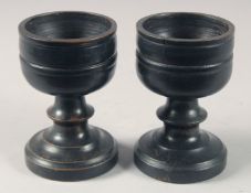 A PAIR OF SMALL TREEN CIRCULAR SALTS. 3.5ins high.