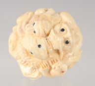 A JAPANESE BONE NETSUKE carved with animals. 3.5cm diameter.