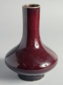A CHINESE FLAMBE GLAZED BOTTLE VASE, 21cm high.