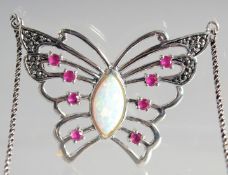 A SILVER RUBY AND OPAL BUTTERFLY PENDANT AND CHAIN.