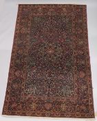 A GOOD PERSIAN CARPET, dark blue ground with floral decoration, attached label; Barin Carpets