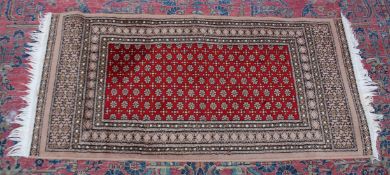 A MODERN PERSIAN DESIGN RUG, central red ground with all over stylised decoration. 4'7