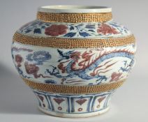 A LARGE CHINESE GILT BLUE AND WHITE DRAGON LOTUS JAR. 12ins high