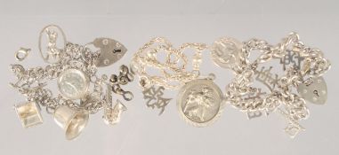 THREE SILVER CHARM BRACELETS.