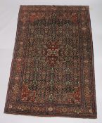 A GOOD PERSIAN CARPET, dark blue ground with floral decoration, attached label; Barin Carpets