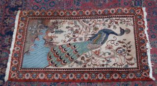 AN UNUSUAL PERSIAN OR INDIAN RUG, the pale cream ground decorated with a peacock in a landscape. 4'