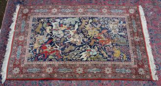 A GOOD PERSIAN HUNTING CARPET, blue ground with figures on horseback with bows and arrows and