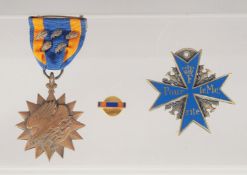 TWO DECORATIVE MEDALS, one with a ribbon.