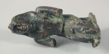 A SMALL EARLY EGYPTIAN BRONZE FIGURE, 6.5cm high.