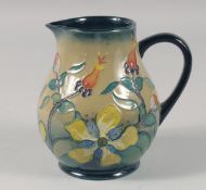 A WILLIAM MOORCROFT FLORAL JUG. Signed W M 5.5ins high.