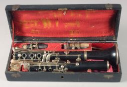 A CLARINET IN A FITTED LEATHER CASE. Case 14ins long.