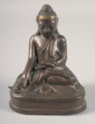 AN EARLY CHINESE BRONZE OF A SEATED BUDDHA with glass eyes. 6.5ins high.