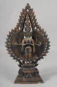 A TIBETAN MULTI ARMED STANDING BRONZE DEITY. 15.5ins high.