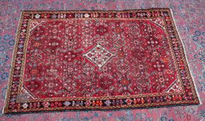 A PERSIAN CARPET, red ground with all over stylised decoration. 6'5